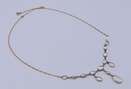 A gold and moonstone necklace (damaged) 46 cm long. 4.6 grammes total weight.
