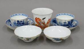 A Chinese porcelain cups and two saucers/covers together with two blue and white porcelain tea