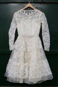 A vintage 1950's lace wedding dress. Approximate bust 80 cm, length 100 cm.