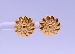 A pair of gold earrings. Each 1.2 cm diameter .2.3 grammes.