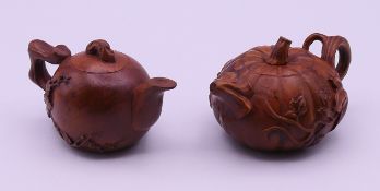Two small wooden teapots. The larger 7.5 cm long.