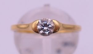An 18 ct gold and diamond solitaire ring. The stone .38 ct. Ring size L/M. 2.8 grammes total weight.