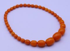 A butterscotch amber necklace. 46 cm long 53.6 grammes total weight.