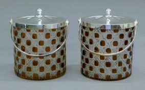 A pair of silverplate-mounted biscuit barrels. Each 14 cm high.