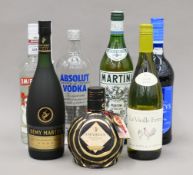 A quantity of bottles of alcohol, including Absolut and Smirnoff vodka,