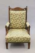 A Victorian upholstered oak armchair. 69 cm wide.