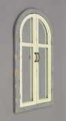 An arch shutter mirror. 101 cm high.