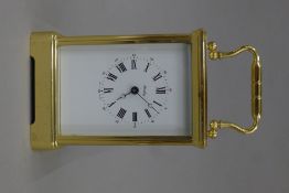 A brass-cased carriage clock. 17.5 cm high overall.