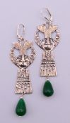 A pair of silver and jade Egyptian revival style earrings. Each 8.