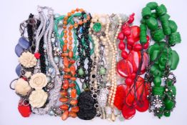 A quantity of costume jewellery. Red necklace 48 cm long.