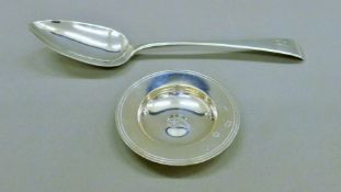 A small silver dish and a Georgian silver serving spoon. The latter 22.5 cm long. 106.3 grammes.