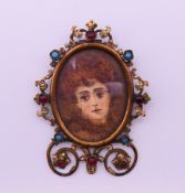 A Victorian portrait miniature of a lady in a cabochon-mounted brass frame (lacking strutt). 7.
