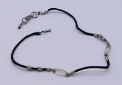 An Art Deco platinum, diamond and rock crystal necklace. 35 cm long.