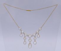 An unmarked gold and moonstone necklace. 42 cm long. 7.9 grammes total weight.