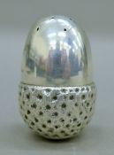 A silver acorn-form pepper engraved with two crests. 6 cm high.