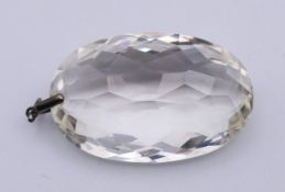 A rock crystal pendant. 6 cm high including suspension loop.
