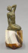 An Art Deco patinated spelter female nude mounted on an onyx plinth. 17 cm high.