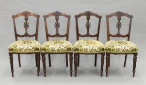 A set of four Victorian walnut dining chairs. Each 45 cm wide.