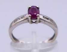 A 9 ct white gold, ruby and diamond ring. Ring size L. 1.7 grammes total weight.