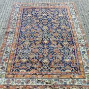 An Eastern red ground wool rug. 186 x 118 cm.