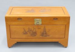 A carved Oriental camphor wood trunk. 104 cm wide.