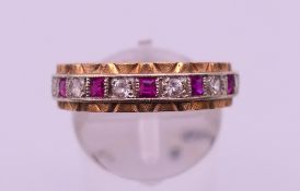 A diamond and ruby eternity ring. Ring size S.