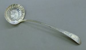 An Irish silver shell bowl ladle. 31 cm long. 175.5 grammes.