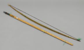 A South Sea Islands tribal bow and arrows. The bow 149 cm long.