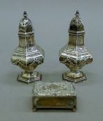 A pair of silver peppers and a silver matchbox cover. The peppers each 9 cm high. 69.1 grammes.