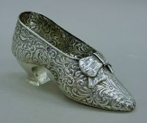 An embossed silver shoe. 19 cm long. 156 grammes.