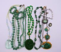 A collection of jade jewellery etc. Dragon pendant 5 cm high.