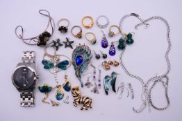 A quantity of costume jewellery and a boxed Guess gentlemen's wristwatch. The watch 4.