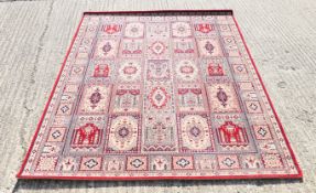 A red ground Persian wool rug. 239 x 171 cm.