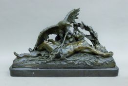 A bronze sculpture of an eagle attacking a female nude and child mounted on a marble plinth base.