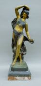A Art Deco-style bronze of a dancing girl mounted on a marble plinth base. 63 cm high.