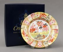 A boxed Royal Crown Derby Imari Garden pattern porcelain plate. 21.5 cm diameter.