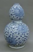 A Chinese blue and white porcelain double gourd vase. 38 cm high.