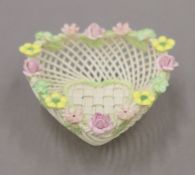 A boxed Belleek heart-shaped porcelain basket. The box 16.5 cm wide.