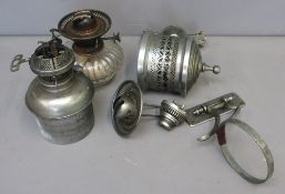 Three Late 19th/Early 20th century oil lamps in various styles, with spare parts, one with clear