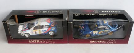 Two 1/18th scale diecast WRC model cars from AutoArt to include 89992 1999 Subaru Impreza #5 Burns/