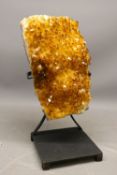 Large citrine panel specimen on stand, comprising an abstract rectangular panel of naturally