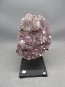 Polished edge amethyst geode on contemporary metal base, comprised of one oval amethyst geode