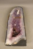 Amethyst geode pyramid specimen, comprising a free-standing pyramid-form geode with a polished cut