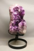 Very large polished amethyst geode specimen on a heavy contemporary metal stand, comprised of one