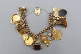Mixed metal curb link heavy charm bracelet, suspending three sovereigns amongst numerous charms,