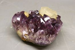 Amethyst geode with large quartz cubic extrusion, comprised of one exposed amethyst matrix including