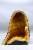 Citrine geode specimen, comprising a free-standing domed-form geode with a polished cut surface