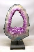 Very large amethyst portal geode, showing a polished hollow cross-section displaying grey-blue agate