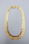 Hallmarked 9ct yellow gold articulated fringe necklet, comprising a flexible brick-link collar