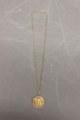Hallmarked 9ct yellow gold sovereign holder with hinged locket reverse and scrollwork edge detail,